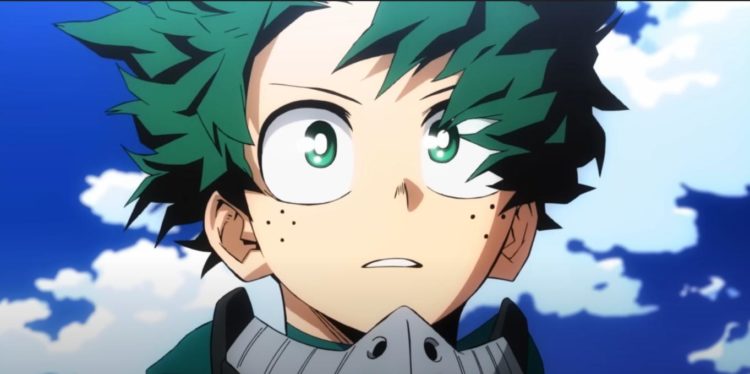 Deku stands in his suit whilst the wind blows his fringe down behind a blue sky