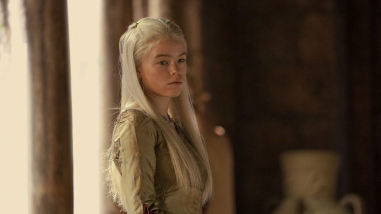 Milly Alcock Young Princess Rhaenyra Targaryen standing in front of pillars in House of the Dragon
