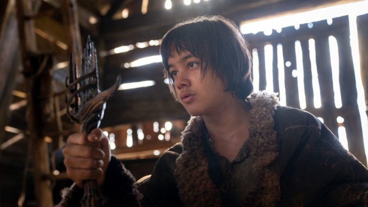 Tyroe Muhafidin as Theo holding a broken sword in The Lord of the Rings: The Rings of Power