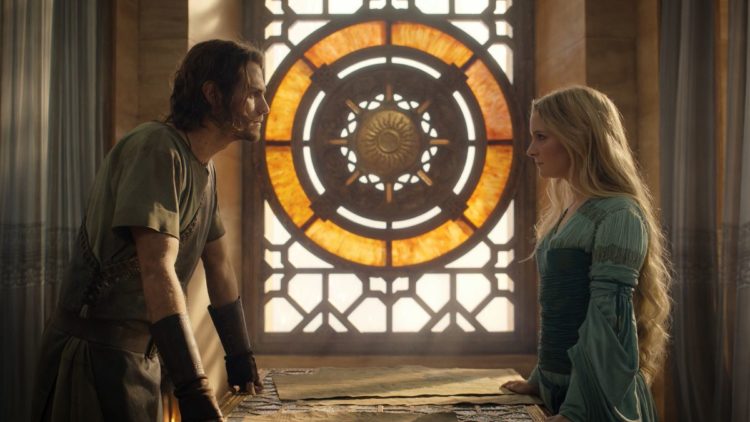 Galadriel (Morfydd Clark) and Halbrand (Charlie Vickers) standing opposite each other in council in The Rings of Power