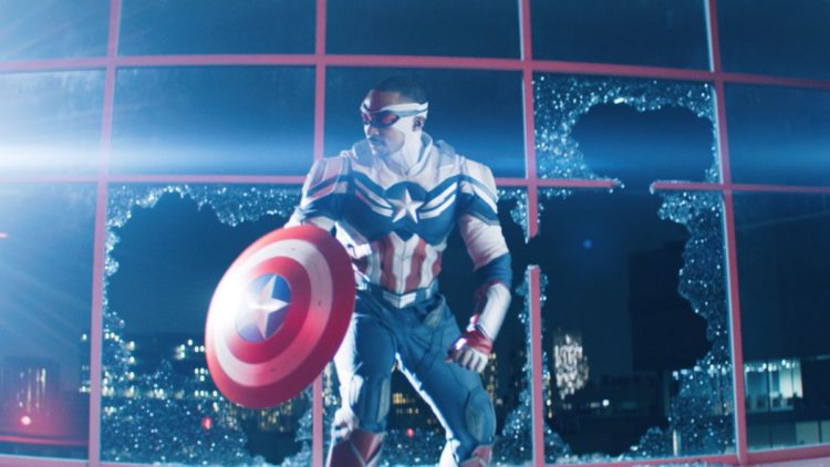 Falcon/Sam Wilson (Anthony Mackie) standing next to a broken window in THE FALCON AND THE WINTER SOLDIER