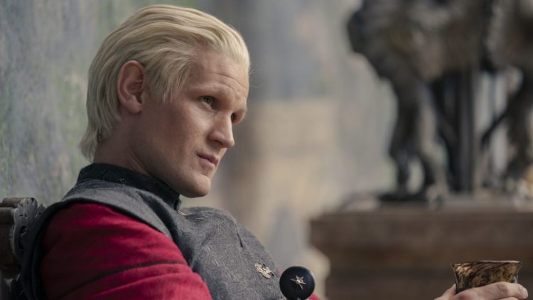 Matt Smith as Daemon sitting with a wine glass in House of the Dragon