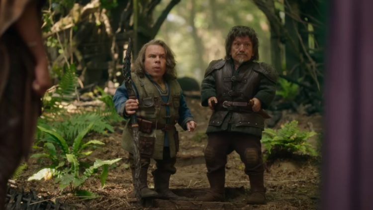 Warwick Davis' Willow standing with a stick in Willow