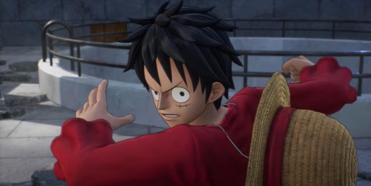 Luffy spins around to glare at the camera as his straw hat bounces off his back
