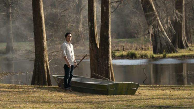 JORDAN RODRIGUES standing next to a boat in National Treasure: Edge of History