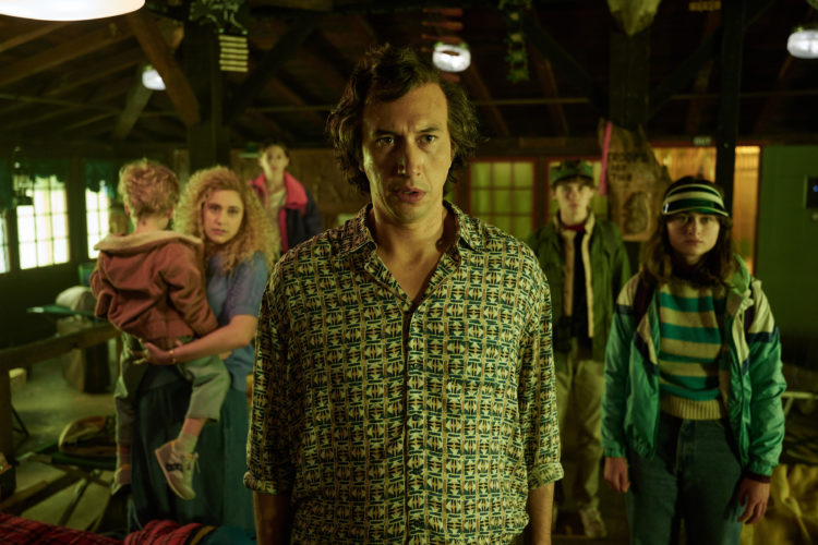 Adam Driver as Prof. Jack Gladney stands with his family in a plaid shirt