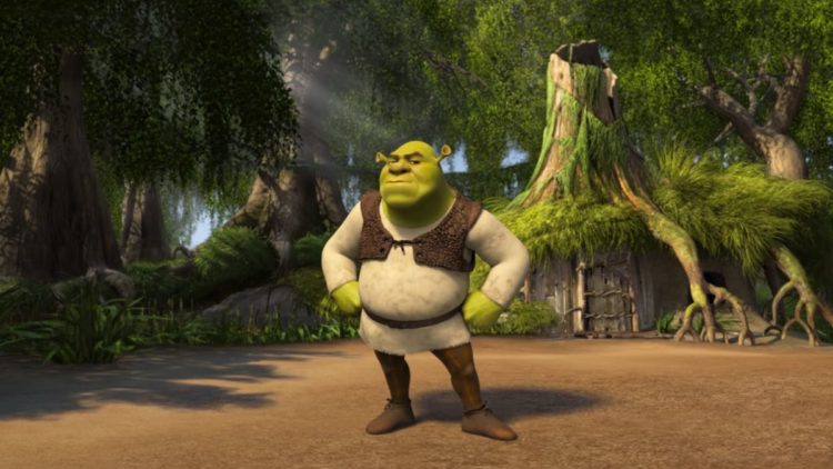 Shrek standing with his hands on his hips at home.