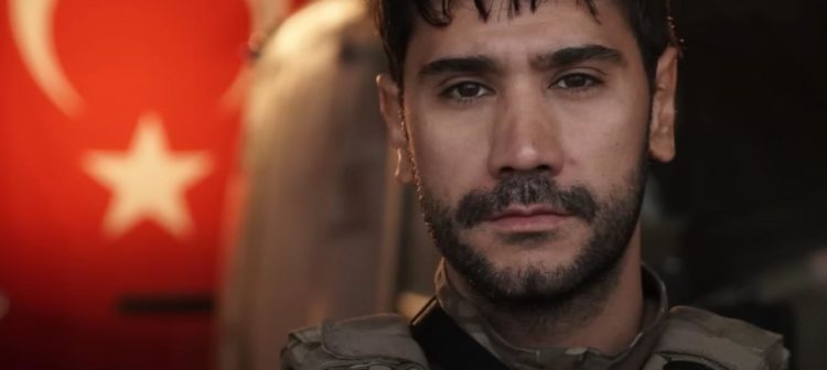 The lead 'Hunter' stands with a Turkish flag waving behind him