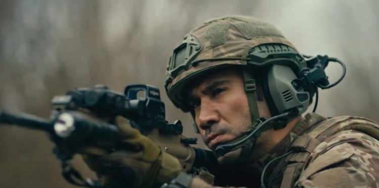 Ugur Gunes as Captain Ali Banazli aims his assault rifle