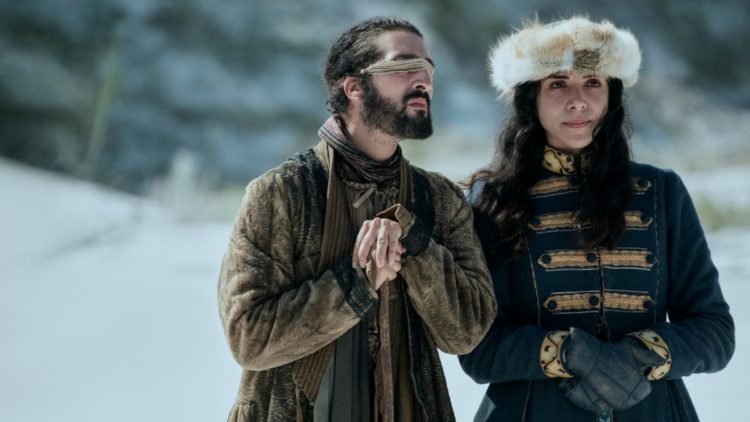 Tolga Safer as Kurya, Hayat Kamille as Mariam waiting in the snow in Vikings: Valhalla
