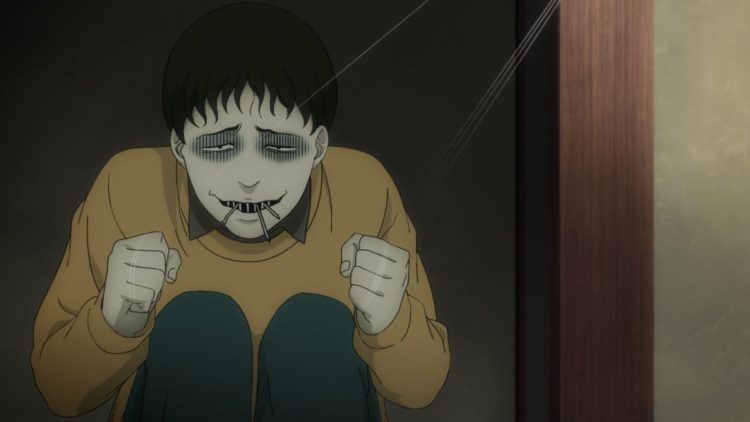 A boy sitting grinning in Junji Ito Maniac: Japanese Tales of the Macabre