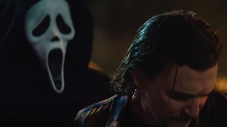 Ghostface standing behind a man in Scream 2022