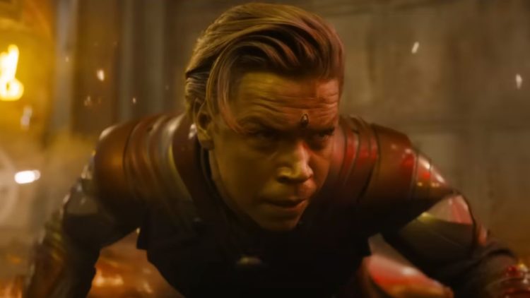 Will Poulter as Adam Warlock crouching with gold hair and skin in Guardians of the Galaxy Vol. 3