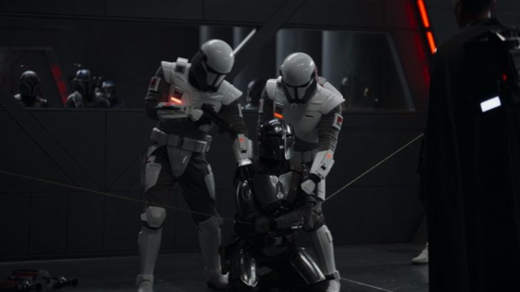 Mando being held captive by Moff Gideon and next-gen Stormtrooper's in The Mandalorian