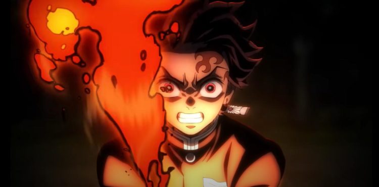 Tanjiro screams as his sword erupts into flames during a night-time battle