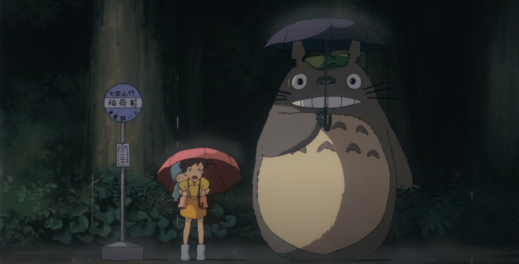 Totoro stands at the catbus station in the rain
